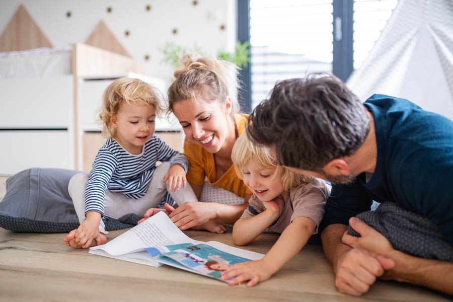 About Our Agency - Happy Family Playing on the Floor with Children